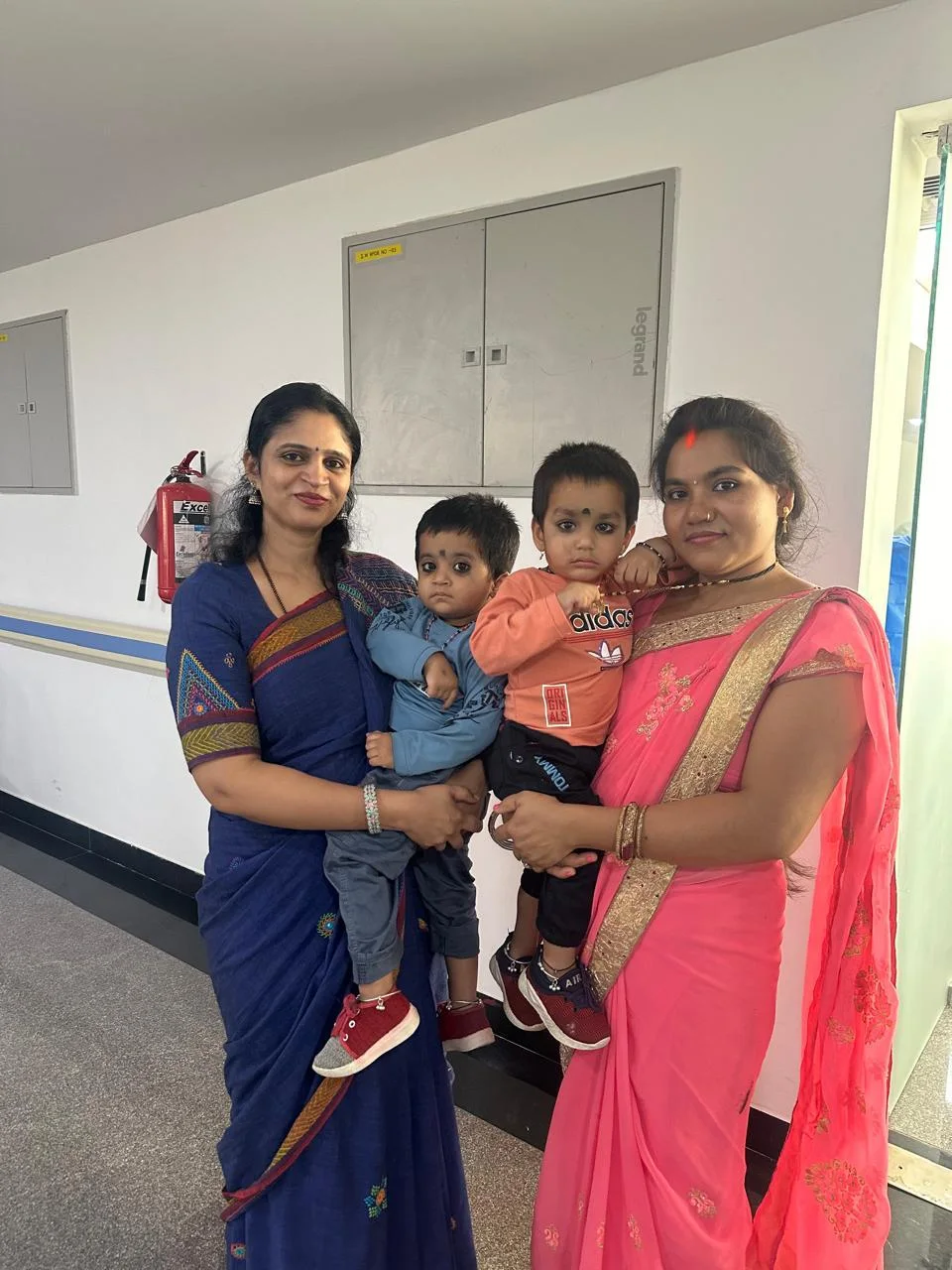 Dr. Aruna with a parent and child at the clinic