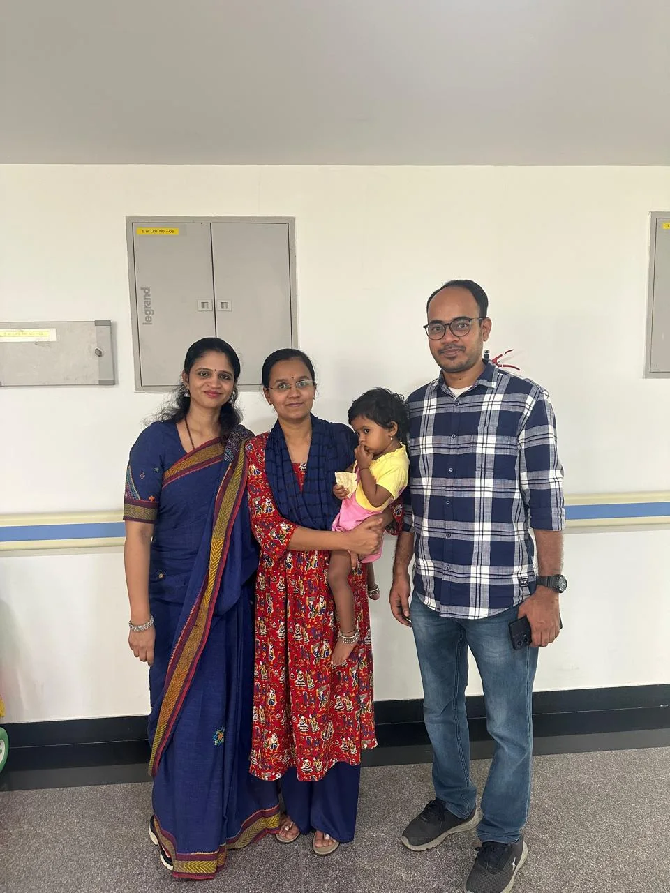 Dr. Aruna with parents and a child at the clinic
